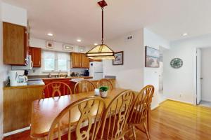 a kitchen and dining room with a wooden table and chairs at Sea Colony --- 2203 Round Robin in Bethany Beach +34 photos