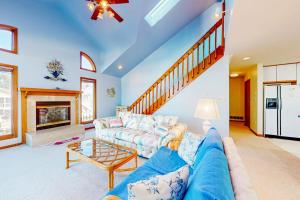 a living room with a blue couch and a table at South Bethany --- 301 W 2nd St in Bethany Beach