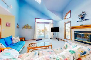 a living room with a couch and a fireplace at South Bethany --- 301 W 2nd St in Bethany Beach