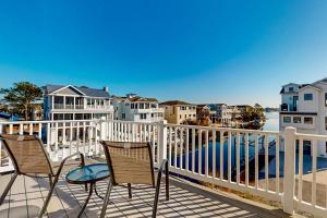 a balcony with two chairs and a view of the water at South Bethany --- 301 W 2nd St in Bethany Beach