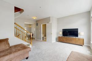 a living room with a couch and a flat screen tv at South Hampton --- 38118 E Chester Ln in Ocean View
