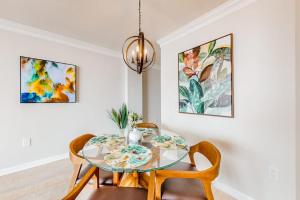 a dining room with a glass table and chairs at Sea Colony - 708 Brandywine House in Bethany Beach