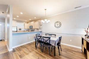 a kitchen and dining room with a table and chairs at The Tides -- 20007 Sandy Bottom # 4202 in Rehoboth Beach
