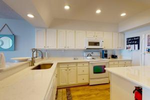 a kitchen with white cabinets and a sink at Sea Colony - 2F Brandywine Garden Rd in Bethany Beach