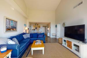 a living room with a blue couch and a tv at Sea Colony - 2F Brandywine Garden Rd in Bethany Beach