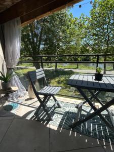a chair and a table on a patio at Les Chicoufs in Saujon
