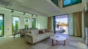 a living room with a couch and a table at Villa Marcy in Belek