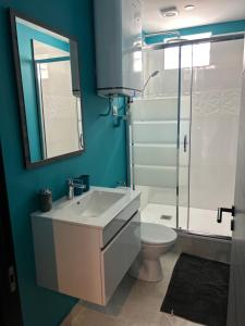 a bathroom with a sink and a toilet and a mirror at Comme à la maison in Villiers-en-Bière