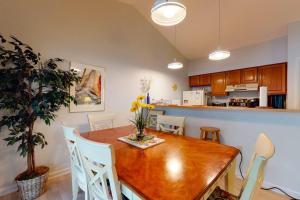 a kitchen and dining room with a wooden table and chairs at Sea Colony - 9603 Timberlake in Bethany Beach
