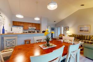 a kitchen and living room with a wooden table and chairs at Sea Colony - 9603 Timberlake in Bethany Beach