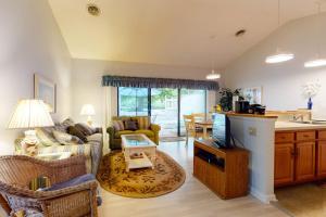 a living room with a couch and a table at Sea Colony - 9603 Timberlake in Bethany Beach