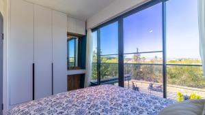 a bedroom with a bed and large windows at Villa Marcy in Belek +73 photos