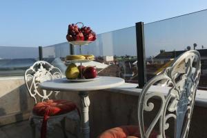a table with a plate of fruit on a balcony at Restwon Suite Hotel in Istanbul