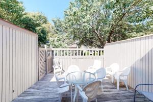 a patio with a glass table and white chairs at Sea Colony - 4003 Volley in Bethany Beach +37 photos