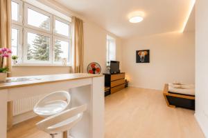 a bathroom with a counter and two chairs in a room at APARTIA Skořepka, Brno-center in Brno +54 photos