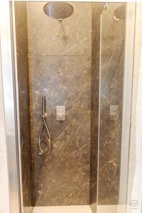 a shower with a glass door in a bathroom at Orefici's Home in Ancona +7 photos