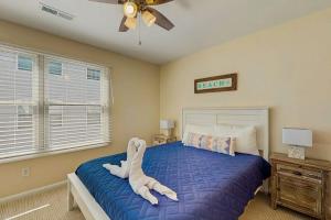 a bedroom with a bed with a white animal on it at Rainbow Cove --- 117 Dagsworthy Ave #B in Dewey Beach +7 photos