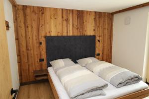 a bed with four pillows on it in a room at Apartments Silvonia in Pallua