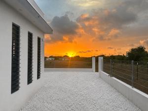 a view from the balcony of a house with the sunset at Casa Trankilo in Fontein +16 photos