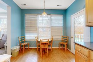 a kitchen with a dining room table and chairs at Bayside Bethany Lakes N Mill #114 in Ocean View