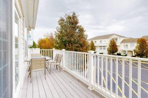 a white balcony with a table and chairs on it at Bayside Bethany Lakes N Mill #114 in Ocean View