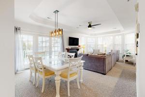 a living room with a table and a couch at Bayside Bethany Lakes N Mill #114 in Ocean View