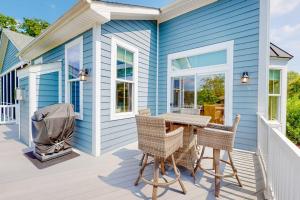 a blue house with a table and chairs on a porch at Bayside Resort --- 38958 Aster Way in Selbyville