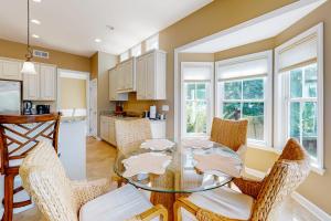 a kitchen and dining room with a glass table and chairs at Bayside Resort --- 38958 Aster Way in Selbyville