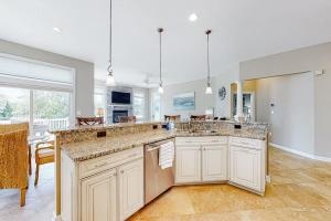 a large kitchen with white cabinets and a large island at Bayside Resort --- 38958 Aster Way in Selbyville