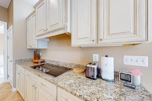 a kitchen with white cabinets and a counter top at Bayside Resort --- 38958 Aster Way in Selbyville +42 photos