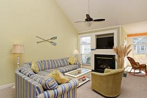 a living room with a couch and a fireplace at Swann Cove - 36858 Herring in Selbyville