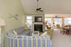 a living room with a couch and a fireplace at Swann Cove - 36858 Herring in Selbyville