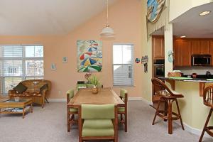a kitchen and dining room with a table and chairs at Swann Cove - 36858 Herring in Selbyville