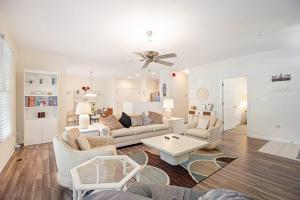 a living room with white furniture and a ceiling fan at Bear Trap Dunes --- 45A Willow Oak in Ocean View