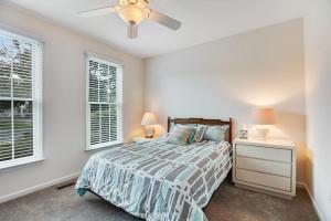 a bedroom with a bed and two windows at Bear Trap Dunes --- 45A Willow Oak in Ocean View +21 photos