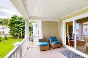 a porch with two chairs and a window at The Peninsula --- 22308 Dune Cir 74 in Millsboro