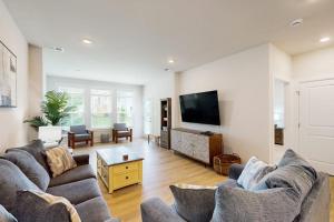 a living room with two couches and a flat screen tv at The Peninsula --- 22308 Dune Cir 74 in Millsboro +37 photos