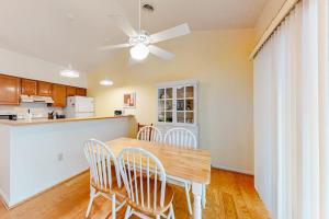 a kitchen with a table and chairs and a ceiling fan at Sea Colony -- 8901 Timberlake in Bethany Beach