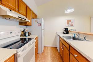 a kitchen with a sink and a white refrigerator at Sea Colony -- 8901 Timberlake in Bethany Beach