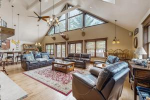 a large living room with couches and a table at Grand Tomahawk Lodge in Tomahawk