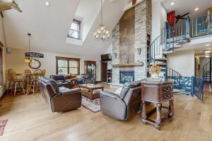 a living room with couches and a fireplace at Grand Tomahawk Lodge in Tomahawk