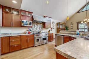 a large kitchen with wooden cabinets and stainless steel appliances at Grand Tomahawk Lodge in Tomahawk +29 photos