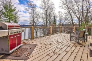 a wooden deck with a stove and a grill at A Place To Gather in Tomahawk