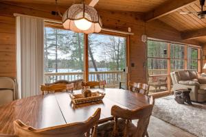 a dining room with a wooden table and chairs at Lakeview North in Lac du Flambeau