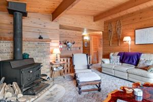 a living room with a couch and a stove at Lakeview North in Lac du Flambeau
