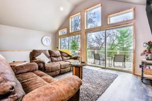 a living room with two couches and a large window at A Place To Gather in Tomahawk
