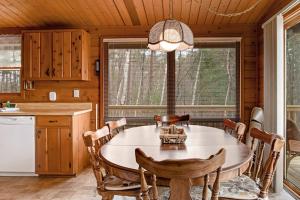a kitchen with a large wooden table and chairs at Lakeview North in Lac du Flambeau