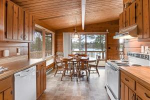 a kitchen with a table and a dining room at Lakeview North in Lac du Flambeau