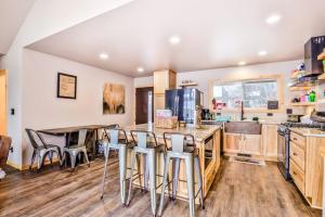 a kitchen with wooden cabinets and bar stools at A Place To Gather in Tomahawk +28 photos