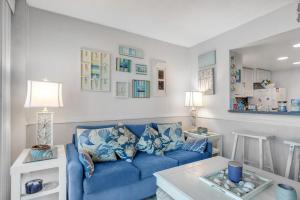 a living room with a blue couch and a table at Sea Colony - 709 Brandywine House Rd in Bethany Beach
